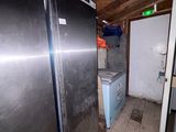 an image of a kitchen with a refrigerator and a refrigerator freezer
