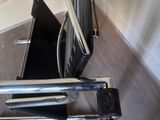 a black chair with a black seat and a black chair with a black seat and a black chair with a black seat and a black chair with a black