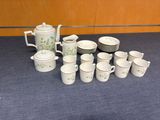 a lot of cups and saucers sitting on a table