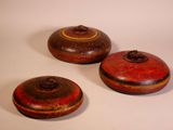 three small wooden containers sitting on top of a white surface