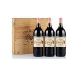three bottles of red wine in a wooden box
