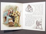 an open book with a picture of a man and a woman sitting on a chair