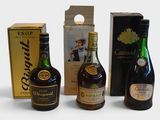 three bottles of alcohol are sitting next to a box of wine