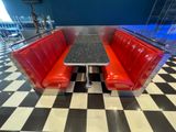 a red booth with a black and white checkered floor