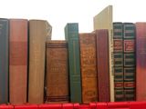 many books in a red box on a white table