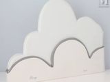 a white cloud shaped bookend sitting on a white table