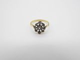 a gold ring with black diamonds on a white background