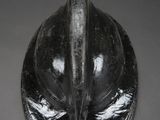 a close up of a black helmet on a gray surface