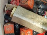 a cardboard box full of beer bottles and a wooden stick