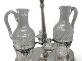 a silver tray with three glass vases on top of it
