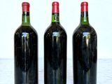 three bottles of wine sitting on a marble table