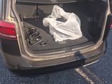the back of a car with its trunk open and a bag in the trunk