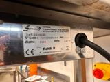 a sign on the back of a machine in a factory
