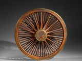 wooden wheel with spokes and spokes on a white surface