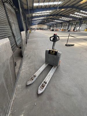 a forklift that is sitting in the middle of a warehouse