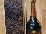 a bottle of champagne sitting next to a box on a table