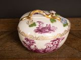 an image of a purple and white bowl sitting on top of a wooden table