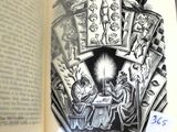an open book with a drawing of a person sitting at a table in front of it