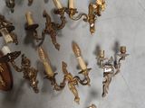 a lot of antique wall sconces on the floor