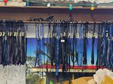 a bunch of leashes hanging from a rack in a room
