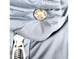 the zipper of a jacket with a button on it
