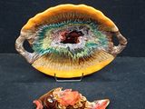 a bowl and a plate with a fish on it on a table