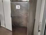 a metallic refrigerator in the middle of a room