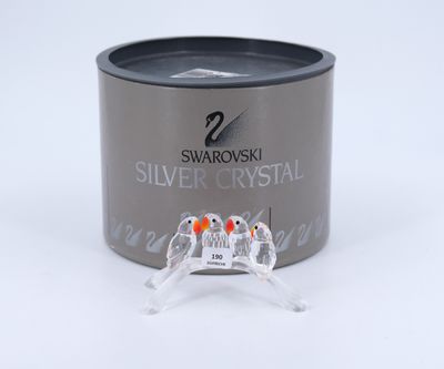 a silver crystal ring sitting on top of a silver container