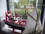 a model of a boat on display in a window