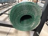 a roll of green cloth on a metal rack
