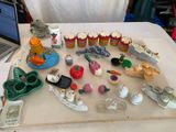 une table sur laquelle se trouvent un ordinateur portable et tout un tas de petites figurines