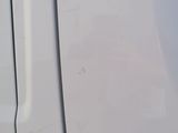 a close up of the door handle of a white truck