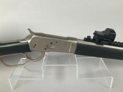 a close up of a gun on display on a clear surface