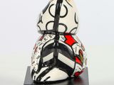 a ceramic figurine of a snail with a crown on it ' s head