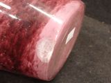 a glass jar with a red liquid inside of it