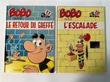 two books on a white table with a cartoon character on them