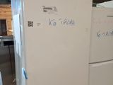 two refrigerators that are sitting in a room