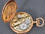 an image of a gold pocket watch with gears inside of it