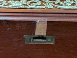 a close up of a piece of wood with a gold decoration on it