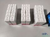 three boxes of lipstick are sitting on a table next to a box of lipstick