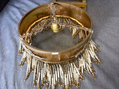a gold purse with fringes hanging from it on a bed