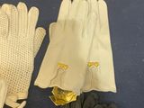 two pairs of white gloves and a pair of black gloves