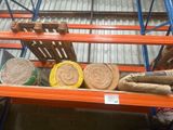 many rolls of paper on a shelf in a warehouse