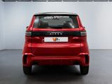 the rear end of a red car parked in a garage