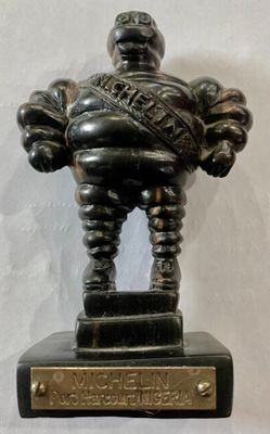 a bronze statue of a man holding a ball