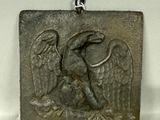 an image of a silver pendant with a bird on it