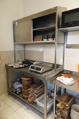a kitchen with a lot of plates and pans on the counter