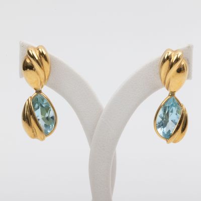 a pair of blue topaze and gold earrings