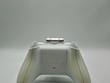 a close up of a game controller on a white surface