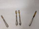 four forks and a knife on the table